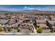 Aerial view of a neighborhood with solar panels and mountain views in the distance at 242 Polaris Ridge Ave, Henderson, NV 89011