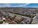 Large neighborhood view with houses featuring red-tiled roofs and backyard landscapes at 242 Polaris Ridge Ave, Henderson, NV 89011