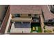 A sunny backyard, featuring an ample patio and a section of faux grass, all enclosed by a sturdy brick wall at 242 Polaris Ridge Ave, Henderson, NV 89011