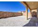 Backyard area showcasing stone pavers, desert landscaping, and a covered patio at 242 Polaris Ridge Ave, Henderson, NV 89011