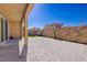 Spacious backyard features a covered patio, pavers, planters, and artificial turf at 242 Polaris Ridge Ave, Henderson, NV 89011