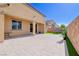 Paver patio with planters, privacy wall, and a small area of artificial turf at 242 Polaris Ridge Ave, Henderson, NV 89011