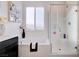 Stylish bathroom features a soaking tub, glass enclosed shower, and a frosted window at 242 Polaris Ridge Ave, Henderson, NV 89011