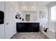 Modern bathroom featuring double sinks, large mirror, and a separate tub and shower at 242 Polaris Ridge Ave, Henderson, NV 89011