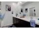 Bathroom featuring double sink vanity, decorated with matching flowers and bath towels at 242 Polaris Ridge Ave, Henderson, NV 89011