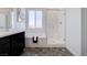 Bright bathroom featuring double vanity, separate tub and shower with glass door and modern finishes at 242 Polaris Ridge Ave, Henderson, NV 89011