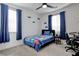 Cozy bedroom featuring bed with Minecraft themed blanket, blue curtains, and ceiling fan at 242 Polaris Ridge Ave, Henderson, NV 89011