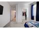 Bedroom with carpeted floor, a view of the hallway, and closet with clothes rack at 242 Polaris Ridge Ave, Henderson, NV 89011