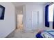 Hallway view of bedroom, shows blue curtains, closet and hallway at 242 Polaris Ridge Ave, Henderson, NV 89011