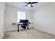 Bright bedroom with a desk setup, featuring carpet flooring and a ceiling fan at 242 Polaris Ridge Ave, Henderson, NV 89011