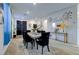 Bright dining area featuring a dining table, modern decor, and a view of the front entrance at 242 Polaris Ridge Ave, Henderson, NV 89011