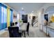 Bright dining area with modern table, stairs, and a view of the front entrance at 242 Polaris Ridge Ave, Henderson, NV 89011