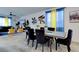 Bright dining area featuring a dining table, modern decor, and colorful window treatments at 242 Polaris Ridge Ave, Henderson, NV 89011