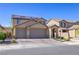 Charming two-story home with a three-car garage, brick driveway, and solar panels at 242 Polaris Ridge Ave, Henderson, NV 89011