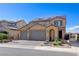 Charming two-story home with a three-car garage, brick driveway, and solar panels at 242 Polaris Ridge Ave, Henderson, NV 89011