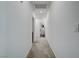 Bright hallway featuring neutral walls and flooring, leading to other rooms at 242 Polaris Ridge Ave, Henderson, NV 89011