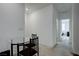 Hallway featuring eating nook with carpet flooring and glass table with chairs at 242 Polaris Ridge Ave, Henderson, NV 89011