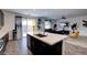 An open-concept kitchen flows seamlessly into the living area, featuring an island with a sink at 242 Polaris Ridge Ave, Henderson, NV 89011