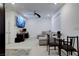 Living area featuring carpet flooring, couch, table with chairs, and a TV at 242 Polaris Ridge Ave, Henderson, NV 89011
