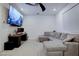 Comfortable living room offers a gray sectional, ceiling fan, media setup, and natural light at 242 Polaris Ridge Ave, Henderson, NV 89011