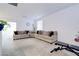 Spacious living room with a large sectional sofa, plush carpeting, and bright natural light at 242 Polaris Ridge Ave, Henderson, NV 89011