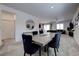 Spacious living room featuring sleek dining area, modern decor, and an open-concept layout at 242 Polaris Ridge Ave, Henderson, NV 89011