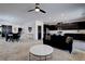 Open-concept living room flows into kitchen, featuring modern decor and a ceiling fan at 242 Polaris Ridge Ave, Henderson, NV 89011