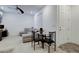Inviting living room with a gray sectional sofa, dining table and a tiled entrance at 242 Polaris Ridge Ave, Henderson, NV 89011