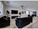 Open living space featuring modern sofas, sleek entertainment area, and stylish dining set at 242 Polaris Ridge Ave, Henderson, NV 89011