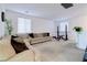Comfortable living room with a sectional sofa, carpet, and a large window for natural light at 242 Polaris Ridge Ave, Henderson, NV 89011