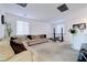 Spacious living room offers a sectional couch, large windows, and an exercise bench at 242 Polaris Ridge Ave, Henderson, NV 89011