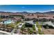 Aerial view shows a sparkling pool and playground within this picturesque community, perfect for relaxation and recreation at 242 Polaris Ridge Ave, Henderson, NV 89011