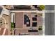 Birds eye view shows solar panels on a home with a tile roof, and a backyard sitting area at 242 Polaris Ridge Ave, Henderson, NV 89011