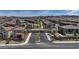A view of the McKnaley community entrance surrounded by new homes, palm trees and professional landscaping at 242 Polaris Ridge Ave, Henderson, NV 89011