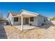 Backyard view of home with patio, block wall, and desert landscaping at 2421 Sunrise Springs Ct, North Las Vegas, NV 89031