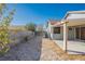 Wide view of the home's backyard and patio area at 2421 Sunrise Springs Ct, North Las Vegas, NV 89031