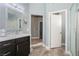 Bathroom boasts granite counters, dark cabinets, and wood-look tile flooring at 2421 Sunrise Springs Ct, North Las Vegas, NV 89031