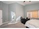 Calm bedroom showcasing neutral walls, soft carpeting, and an attached bathroom with natural light at 2421 Sunrise Springs Ct, North Las Vegas, NV 89031