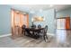 Elegant dining room area featuring wood-look floors, natural light, and neutral wall paint at 2421 Sunrise Springs Ct, North Las Vegas, NV 89031