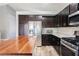 Modern kitchen featuring stainless steel appliances, granite countertops, a stylish backsplash, and wood-look flooring at 2421 Sunrise Springs Ct, North Las Vegas, NV 89031