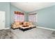 Comfortable living room featuring neutral wall paint, soft carpeting, natural light, and stylish decor at 2421 Sunrise Springs Ct, North Las Vegas, NV 89031