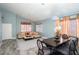 Open floor plan featuring a living room with wood-look floors, a dining area, and neutral wall paint at 2421 Sunrise Springs Ct, North Las Vegas, NV 89031