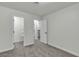 Neutral bedroom with carpeted floor, walk-in closet and a white door leading to the home's stairway at 2461 Old Forge Ln # 103, Las Vegas, NV 89121