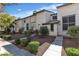Charming exterior of a townhome with landscaped front yard and a concrete walkway at 2461 Old Forge Ln # 103, Las Vegas, NV 89121