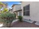 Exterior of a townhome showcasing neat landscaping and a tiled roof under a blue sky at 2461 Old Forge Ln # 103, Las Vegas, NV 89121