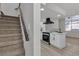Kitchen and staircase combination showing stainless steel appliances, and quartz countertops at 2461 Old Forge Ln # 103, Las Vegas, NV 89121