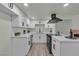 Updated kitchen features stainless steel appliances, quartz countertops and light wood flooring at 2461 Old Forge Ln # 103, Las Vegas, NV 89121