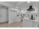 Stylish white kitchen featuring stainless steel appliances and quartz countertops at 2461 Old Forge Ln # 103, Las Vegas, NV 89121