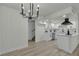 A view of the living room leading into the kitchen area, featuring light flooring and a fireplace at 2461 Old Forge Ln # 103, Las Vegas, NV 89121