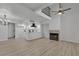Spacious living room with a fireplace, modern lighting, and light wood flooring at 2461 Old Forge Ln # 103, Las Vegas, NV 89121